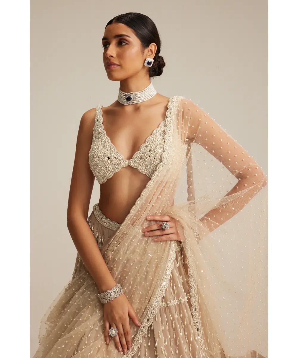 VVANI VATS- Light Beige Pearl Drop Multi Tier Lehenga Set.